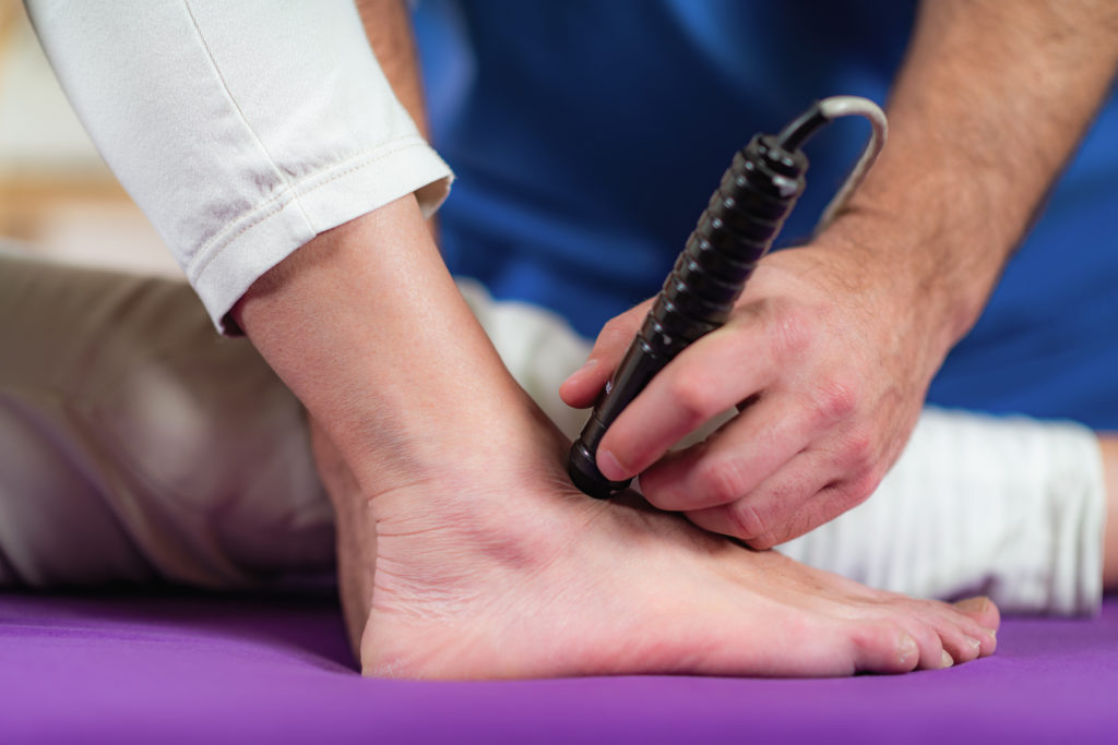 Laser,Physical,Therapy.,Physical,Therapist,Treating,Senior,Woman's,Foot,In